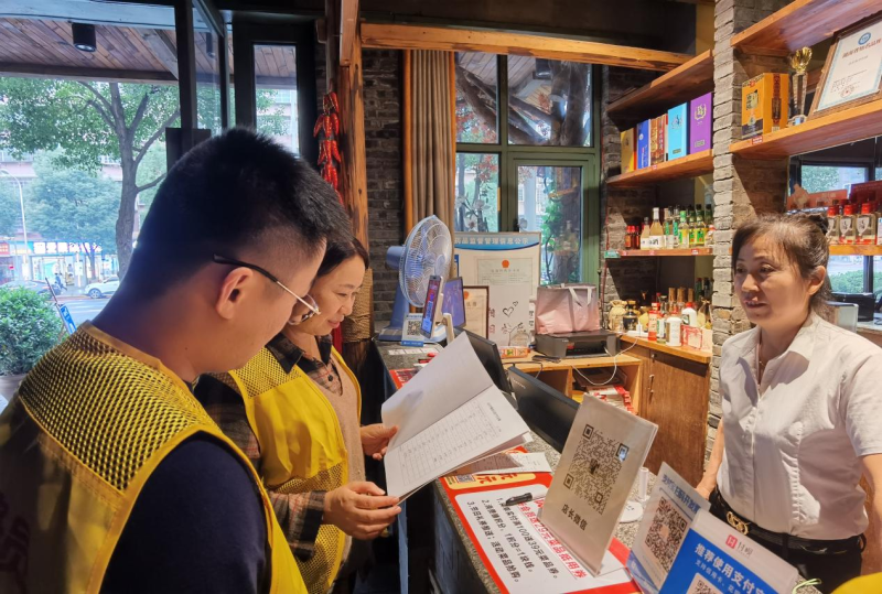 金桂社区网格员检查餐饮门店油烟净化器清洗台账。
